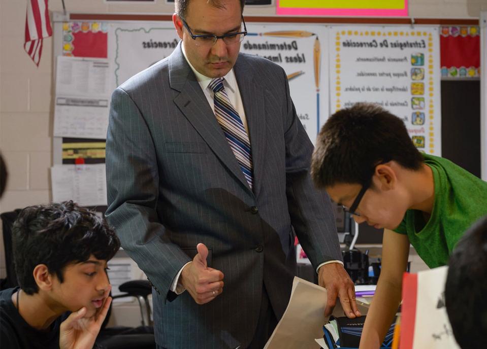 a teacher working with middleschool students